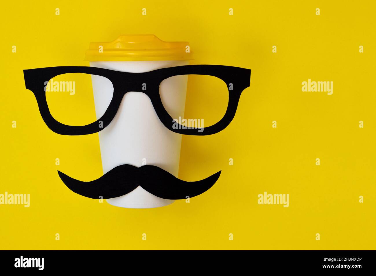happy father day concept, black mustache and eyeglasses on paper cup for coffee on yellow background with empty space for text Stock Photo