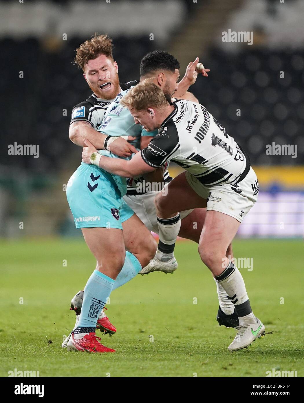 Hull FC's Scott Taylor and Jordan Johnstone tackle Wakefield Trinity's Kelepi Tanginoa during the Betfred Super League match at the KCOM Stadium, Hull. Picture date: Friday April 23, 2021. Stock Photo