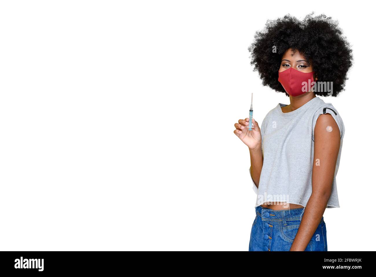 young teenager wearing a covid-19 protective mask being vaccinated COVID-19 Stock Photo