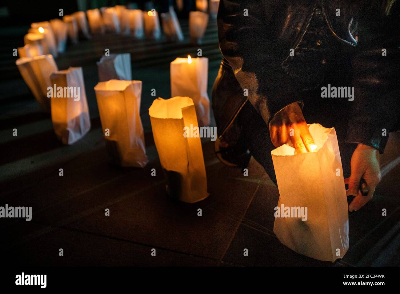 Bikfaya, Lebanon. 23rd Apr, 2021. A woman relights candles that have
