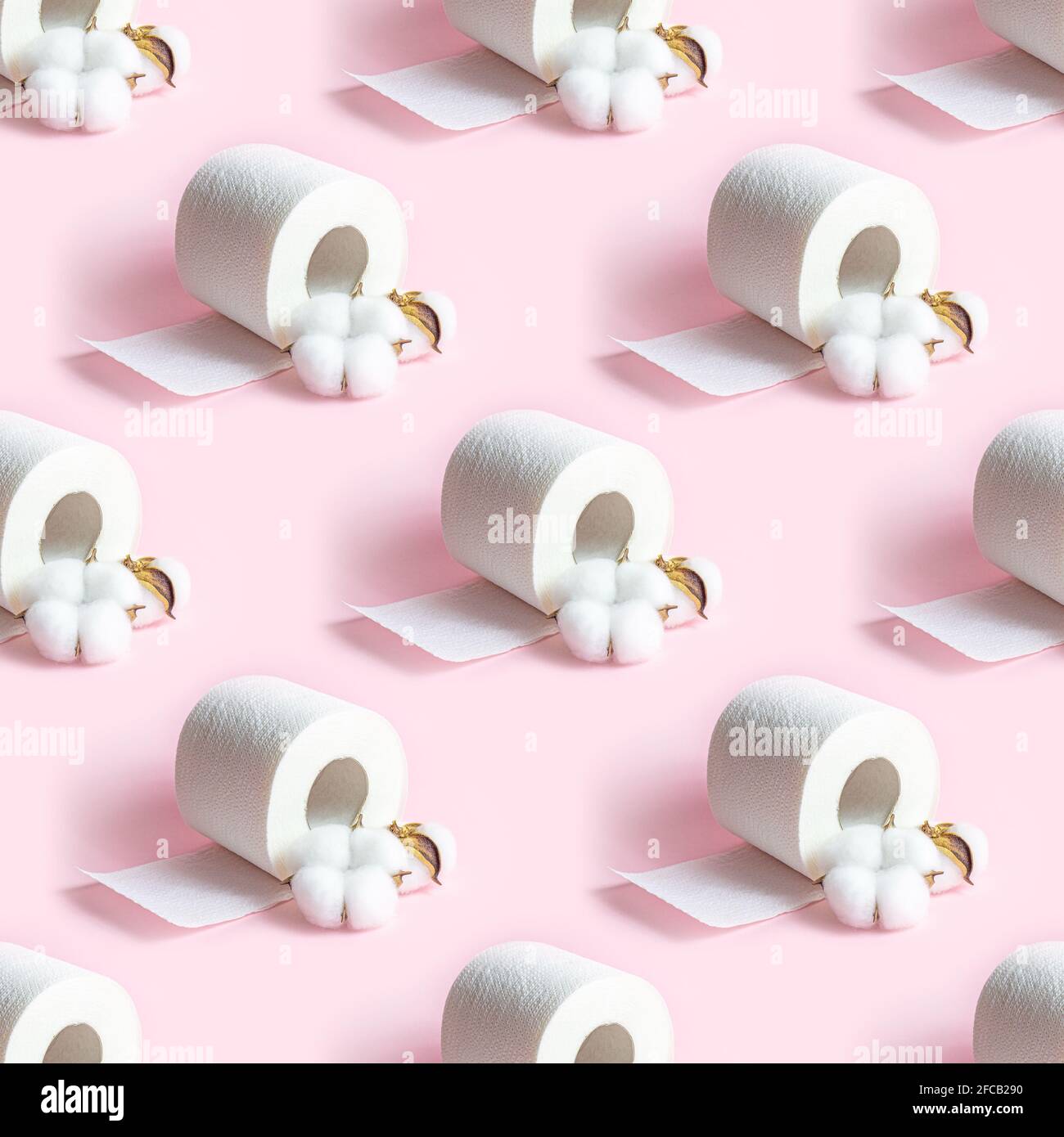 White toilet paper roll repeat seamless pattern on light pink background. Stock Photo