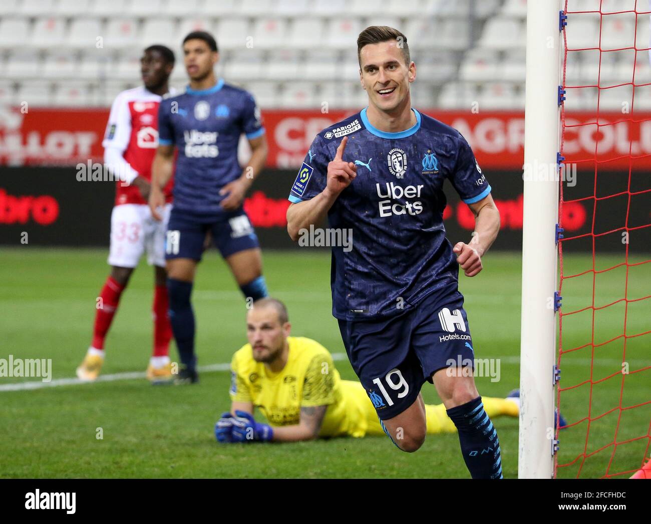 Arkadiusz Milik of Marseille celebrates his goal (ultimately cancelled) while goalkeeper of Reims Predrag Rajkovic lies down during the French championship Ligue 1 football match between Stade de Reims and Olympique de Marseille (OM) on April 23, 2021 at Stade Auguste Delaune in Reims, France - Photo Jean Catuffe / DPPI Stock Photo