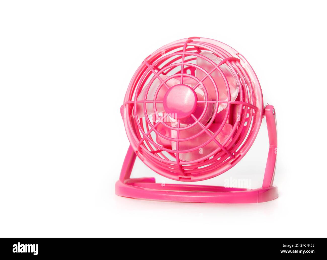 Mini fan. Portable battery operated hot pink small table ventilator to cool down and circulate air during hot summer days. Use at the office, car trip Stock Photo
