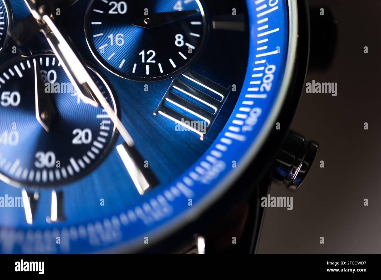 Close Up of Roman Numeral Four on Blue Faced Chronograph Watch Stock Photo