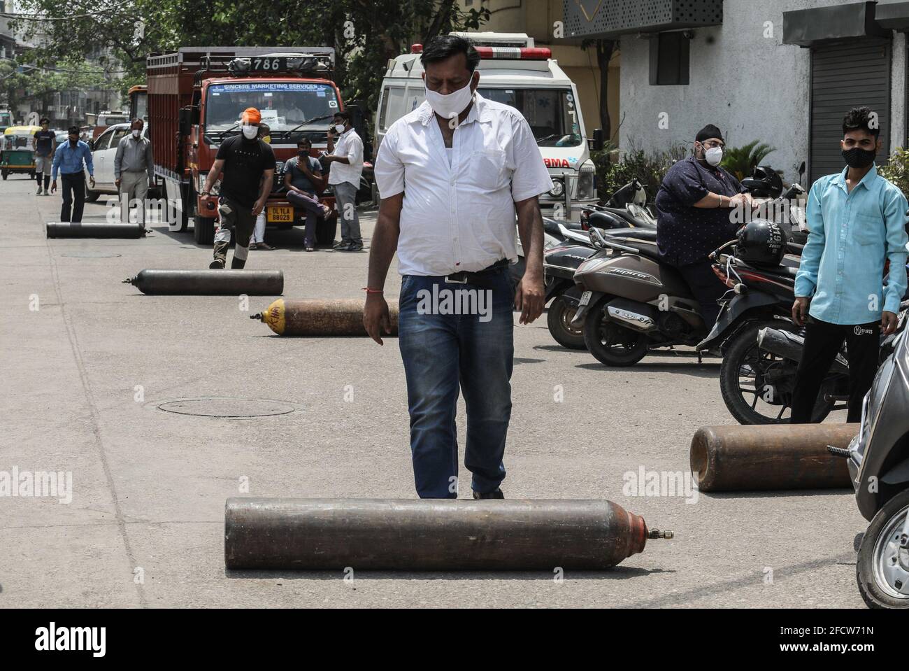 New Delhi, India. 23rd Apr, 2021. Family members of Covid-19 infected patients move with empty cylinders to refill outside the oxygen filling center in New Delhi. India is running out of oxygen during the second wave of Covid-19 pandemic. India has recorded 332,730 new Covid-19 cases in a single day and 2,263 deaths in the last one day. (Photo by Naveen Sharma/SOPA Images/Sipa USA) Credit: Sipa USA/Alamy Live News Stock Photo