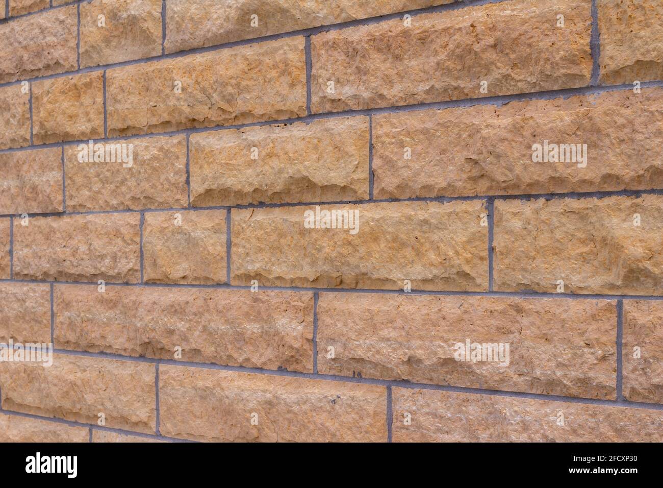 Natural rough textured stone block wall background in shades of beige ...