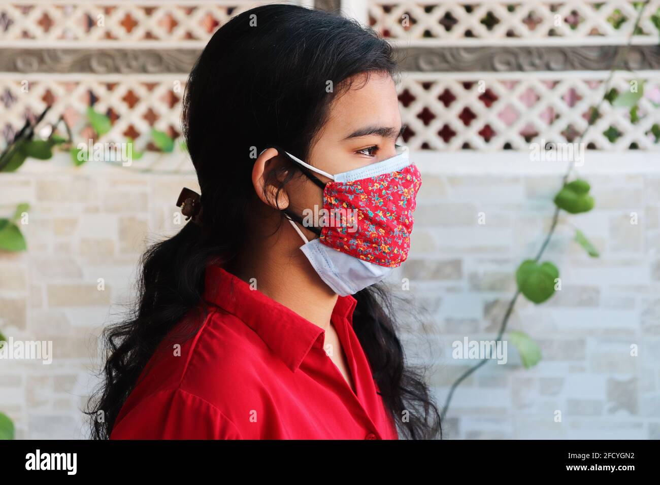 double mask prevent infection, Young indian girl wearing two face mask to protect from new strain of coronavirus or new wave of covid-19 outbreak in i Stock Photo