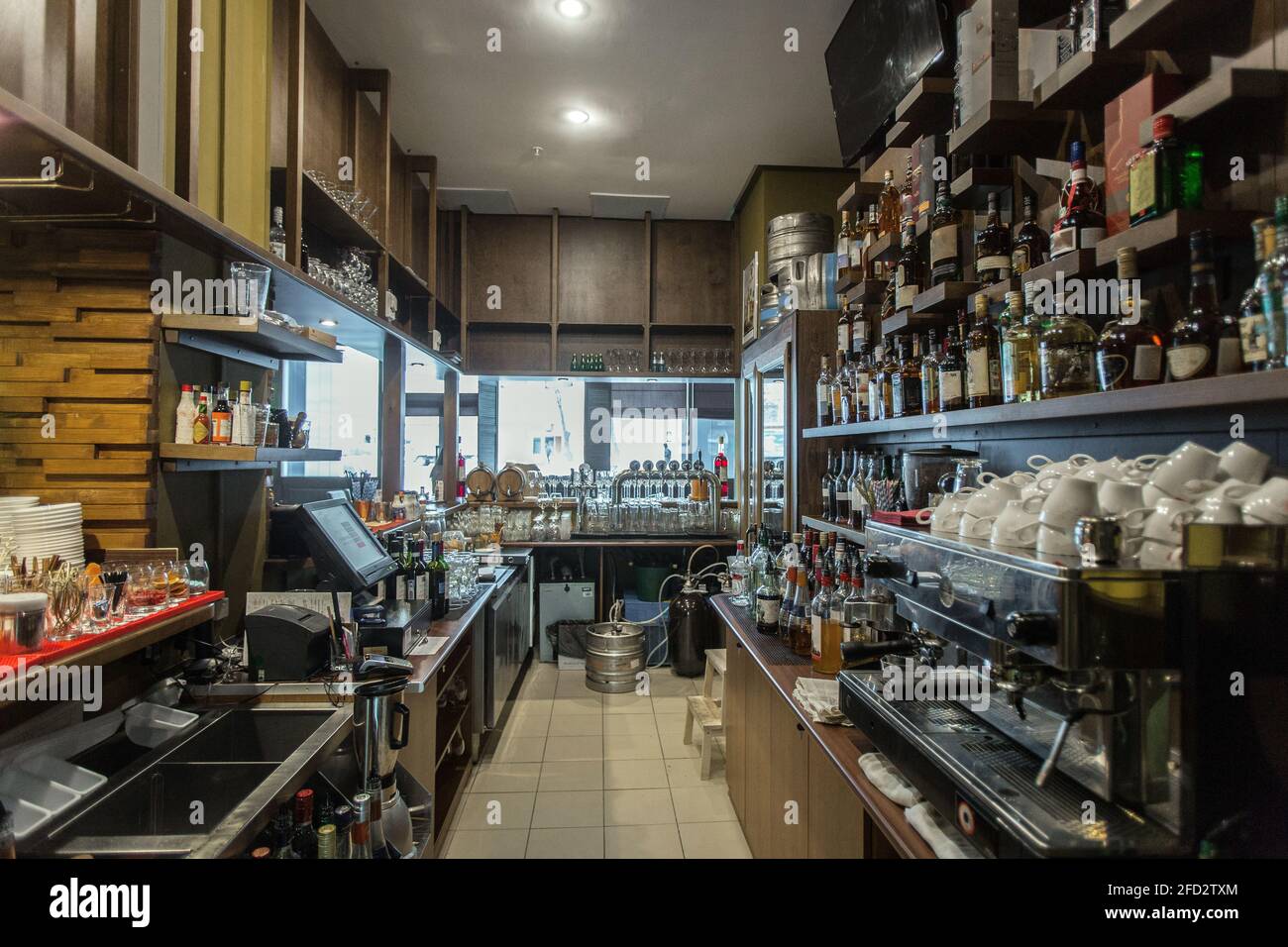 Perspective view of interior of coffee shop with assorted dishes and coffeemaker on counter Stock Photo