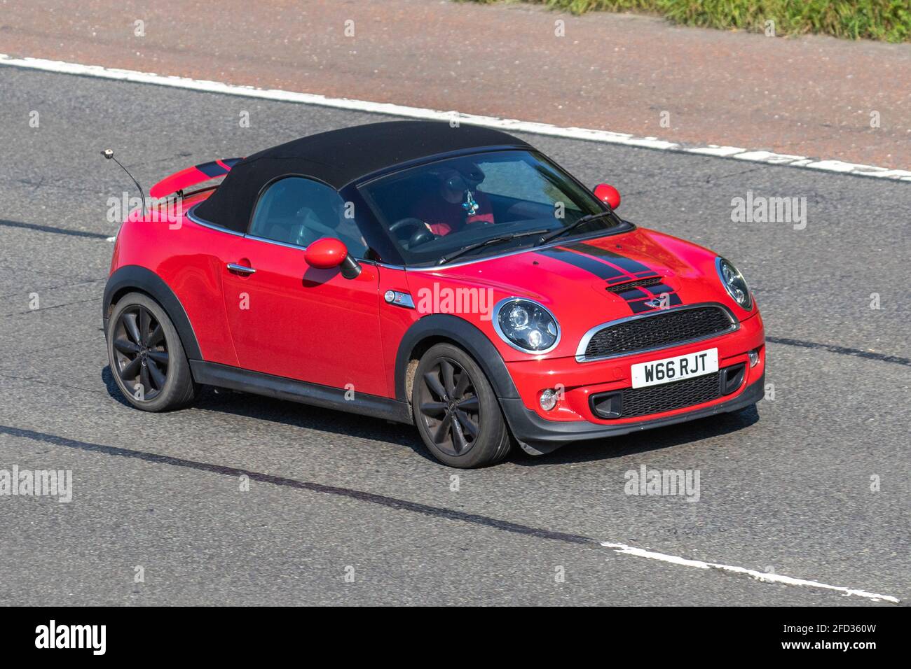 2013 red mini Roadster 1598cc moving vehicles, cars, vehicle driving on UK roads, motors, motoring on the M6 English motorway road network Stock Photo