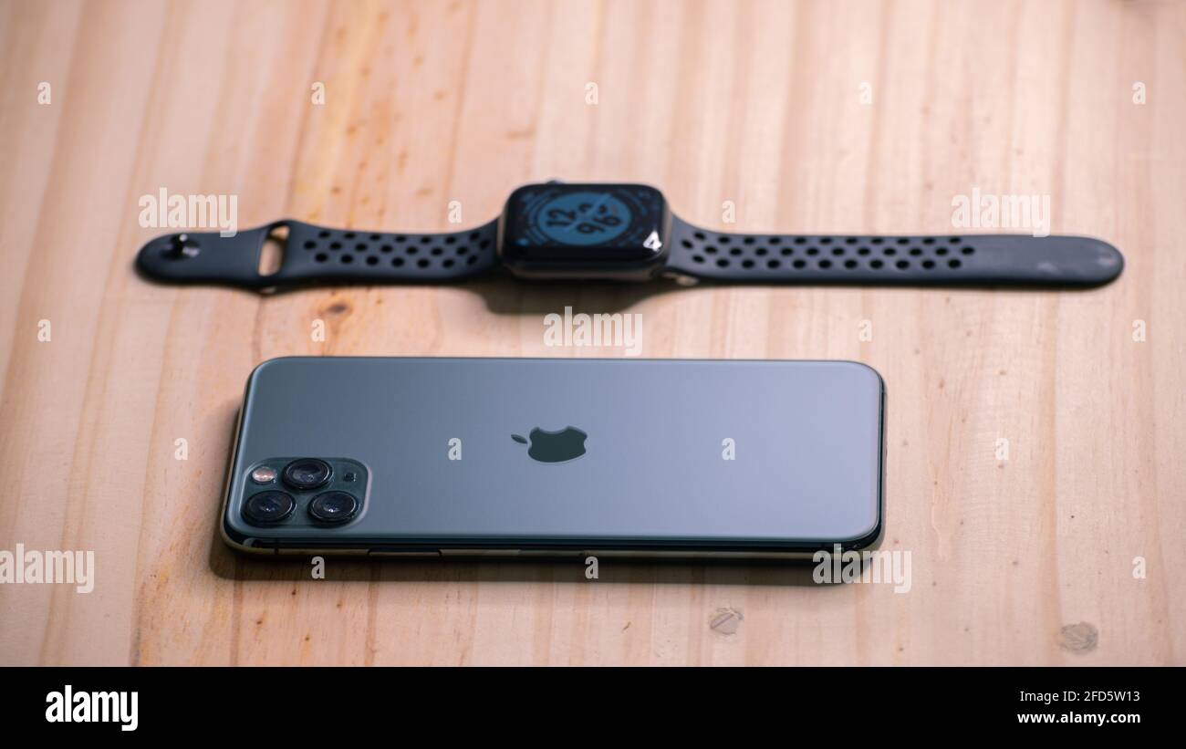 Galle, Sri Lanka - 02 19 2021: Apple iPhone 11 pro max and apple watch series 6 lay flat on a wooden table, luxury and lifestyle concept. Stock Photo