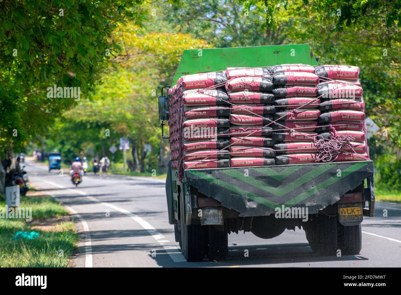 Pile of cement bags transport via lorry, heavy and move slowly in the