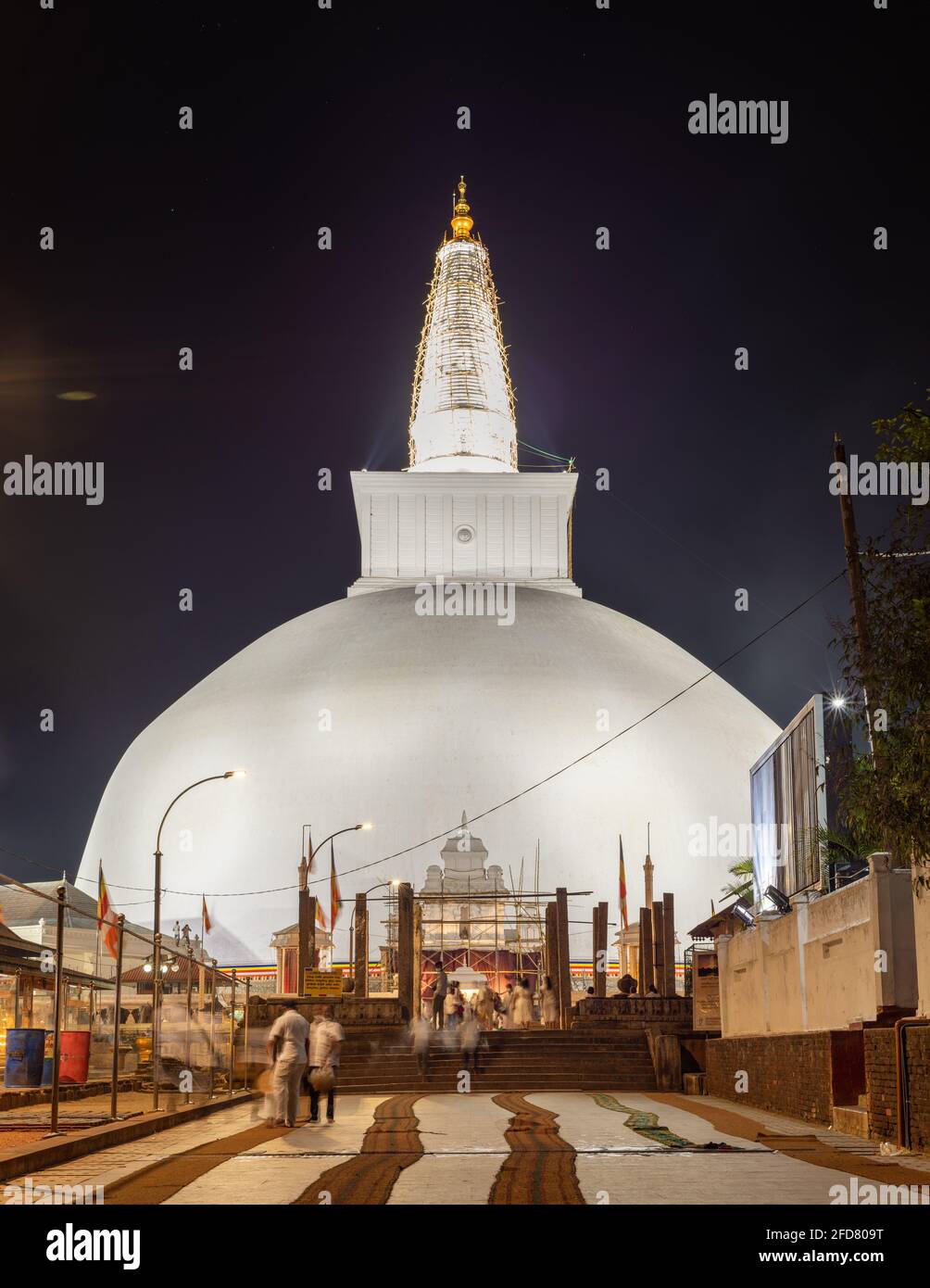 Ruwanwelisaya stupa glowing in the night, it is a hemispherical structure and containing sacred Buddha's relics built by King Dutugamunu. Stock Photo