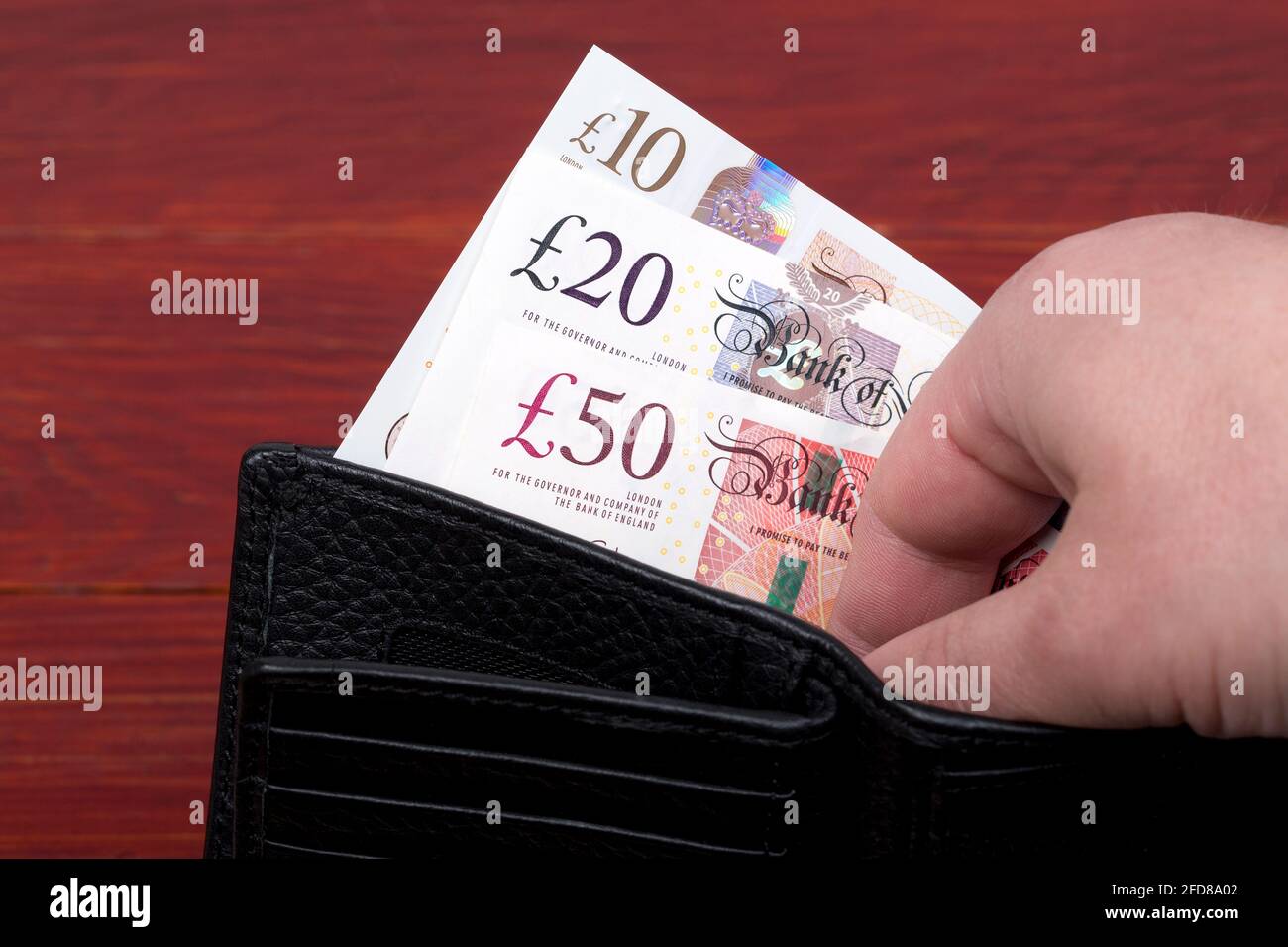 English money pounds in a black wallet Stock Photo Alamy