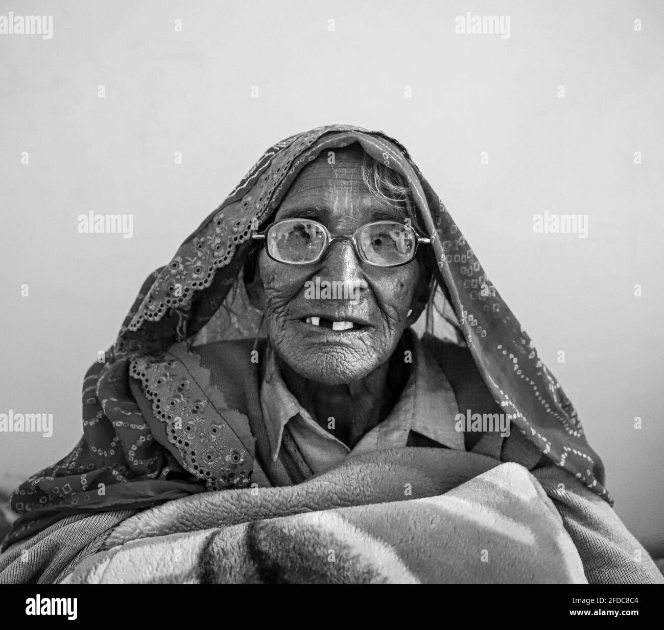 black and white portrait of senior indian woman,having wrinkles on her face. Stock Photo