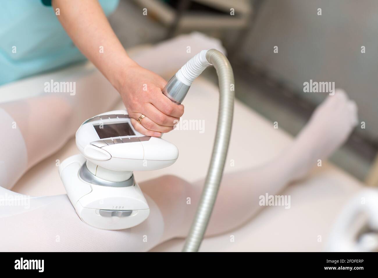 Young beautiful woman and LPG massage procedure in spa clinic. Lymphatic drainage massage LPG apparatus process Stock Photo