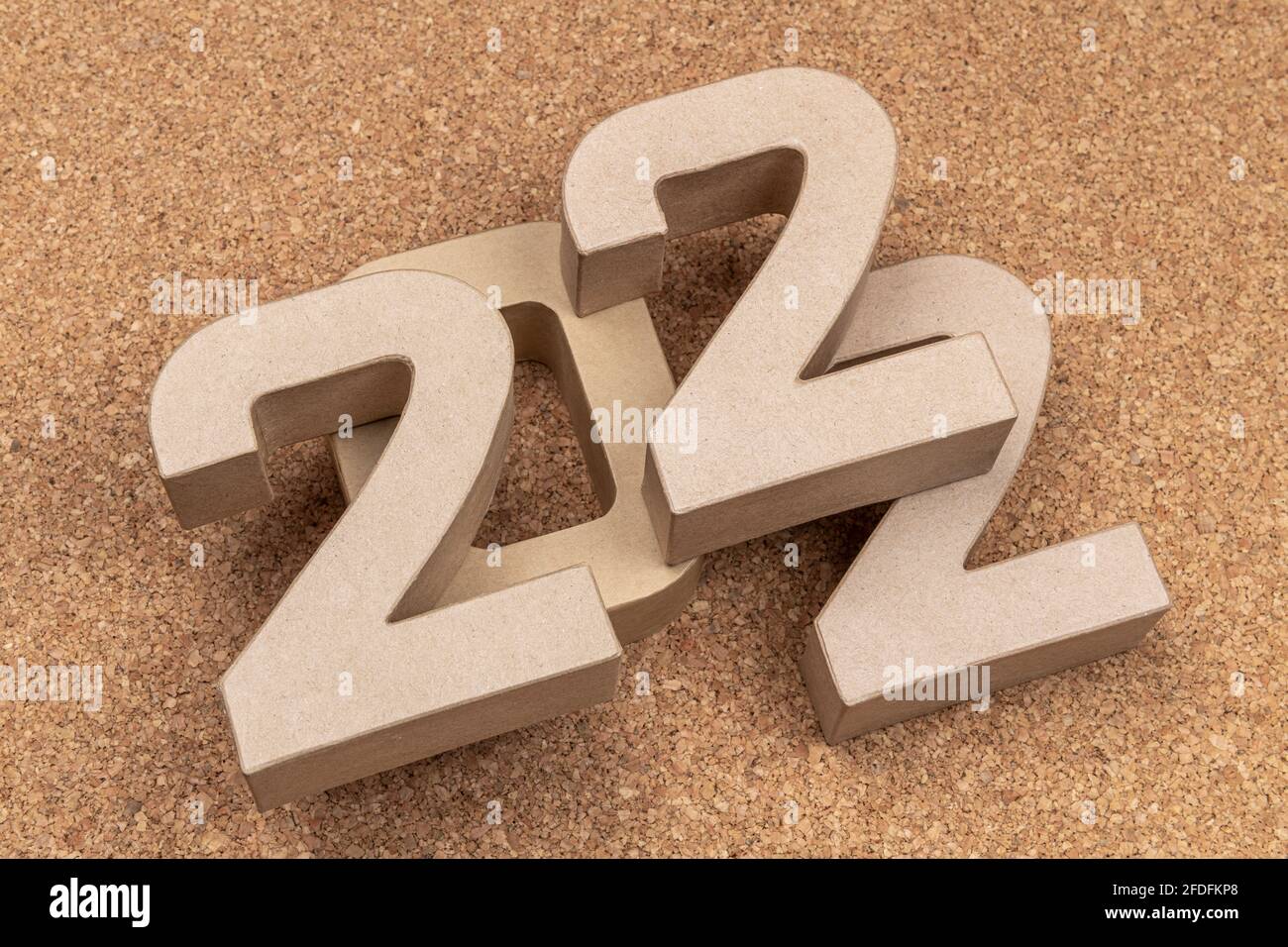 The year twenty twentytwo in large cardboard numbers on a cork