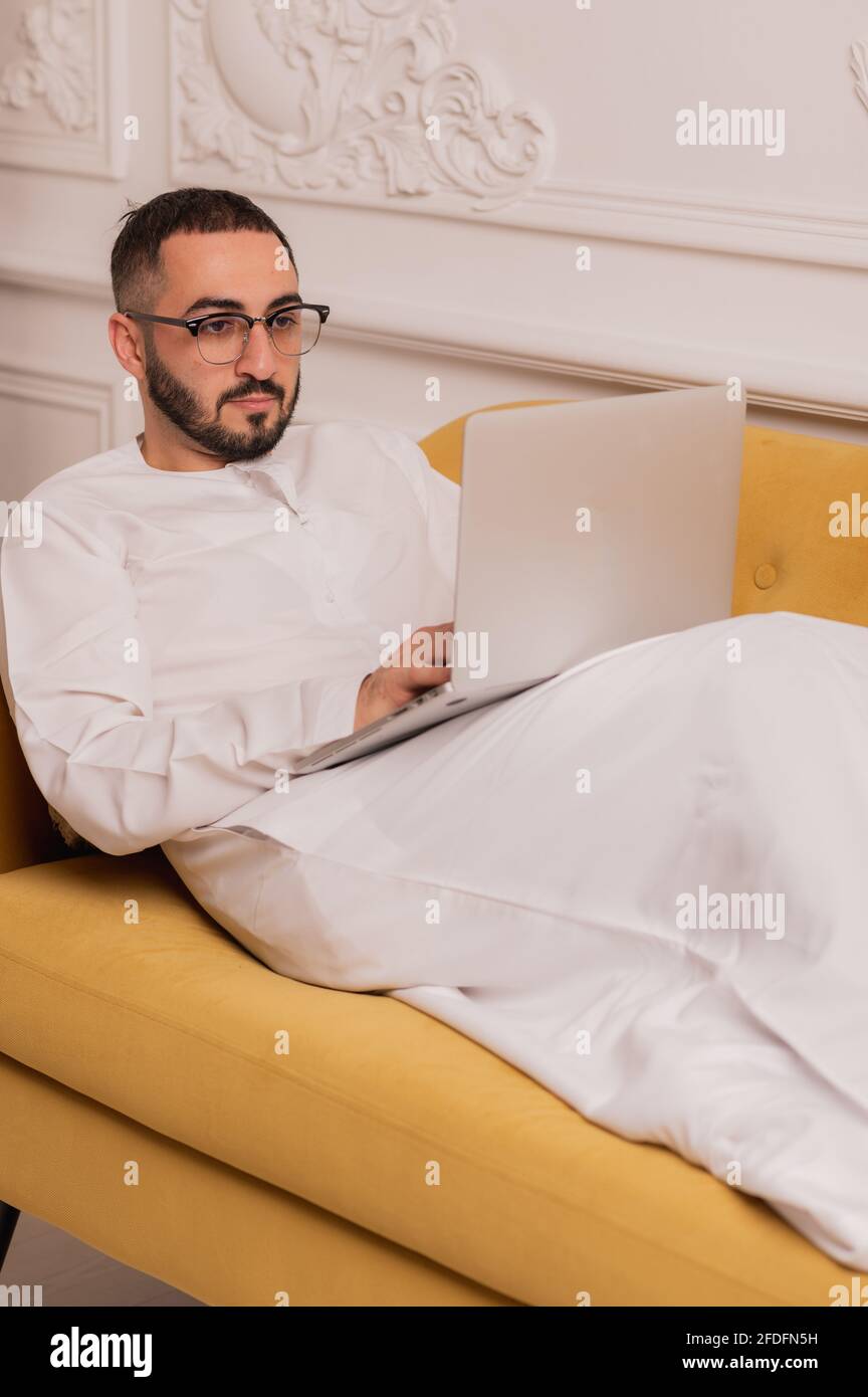 Arab businessman working on laptop computer at home Stock Photo