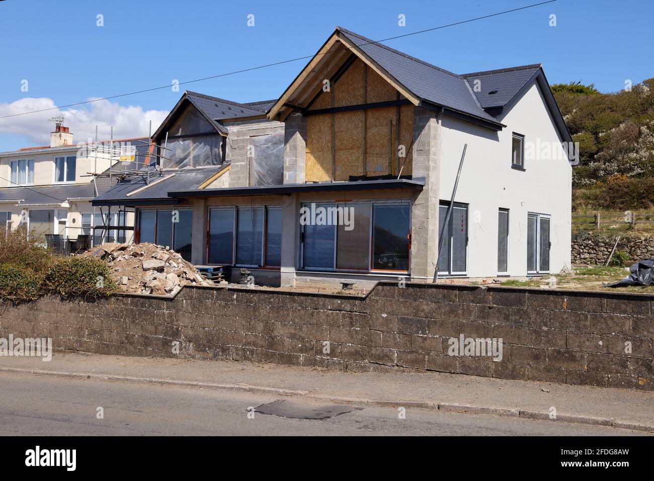 A new build being constructed on the site of an old bungalow plot along