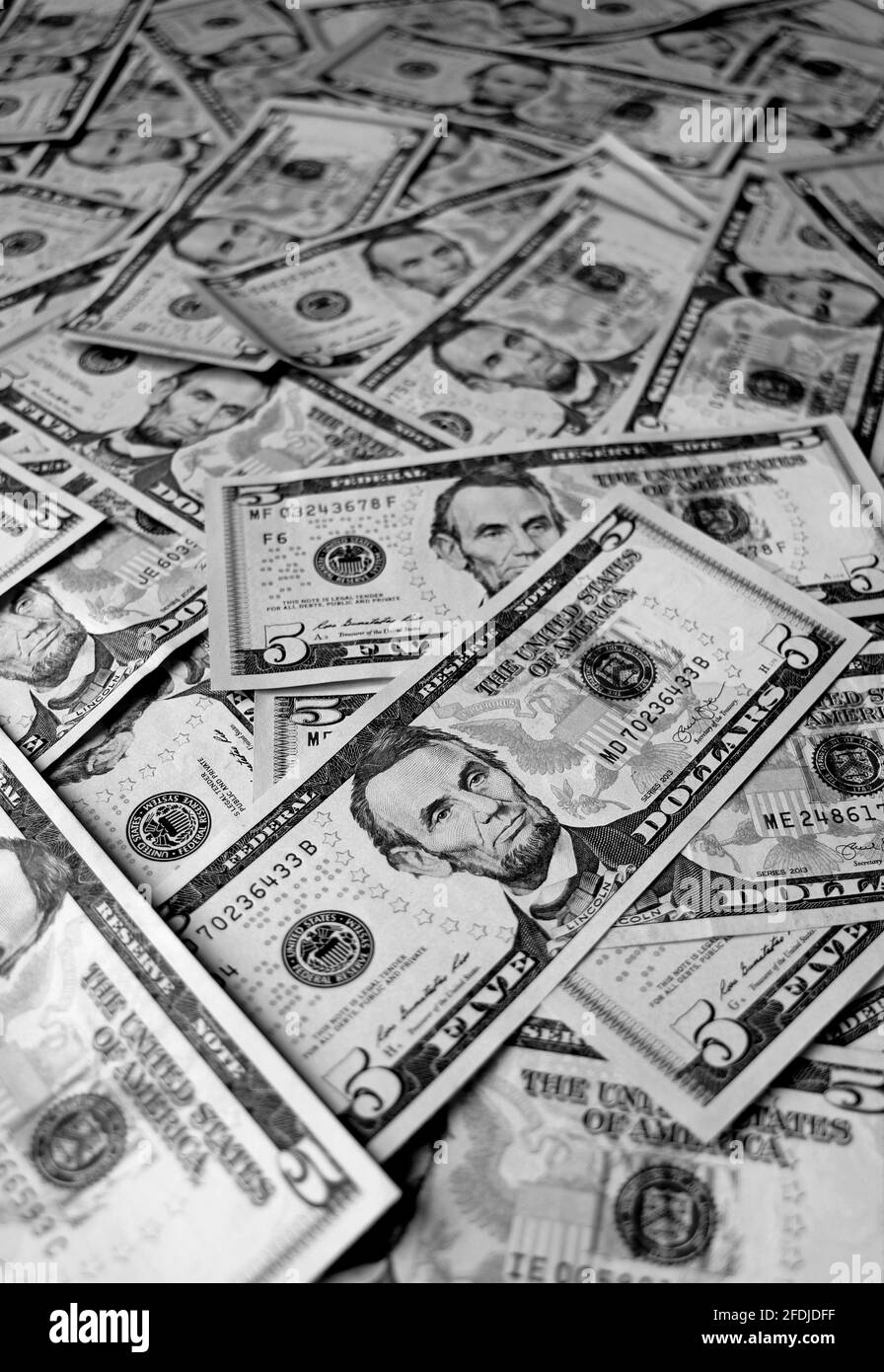 Vertical image of Heap of United States Five Dollar Bills in Monochrome Stock Photo