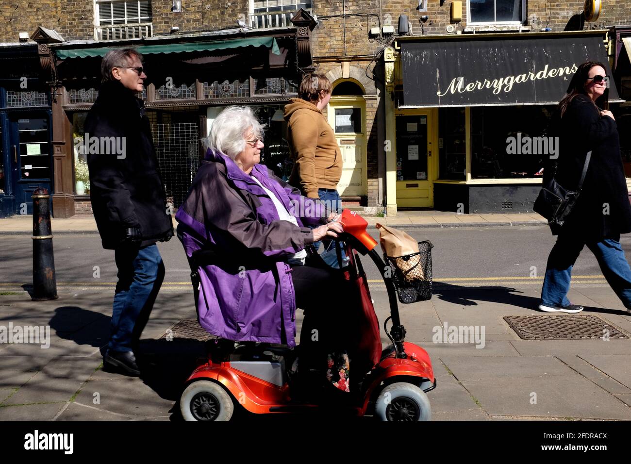 disabled woman in a mobility scooter,deal town,east kent,uk april 2021 Stock Photo