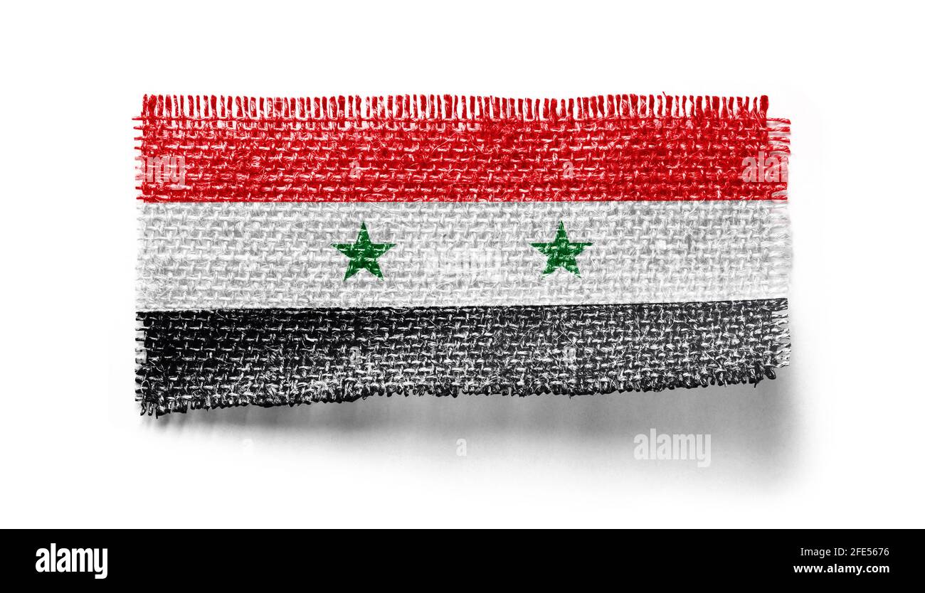 Syria flag on a piece of cloth on a white background Stock Photo