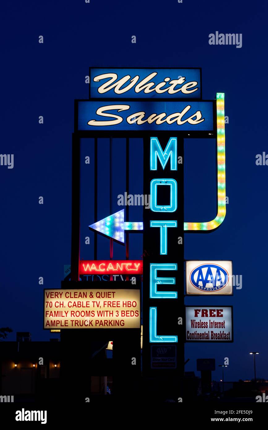 The brightly lit neon sign for the White Sands Motel in Alamogordo, New Mexico. Stock Photo
