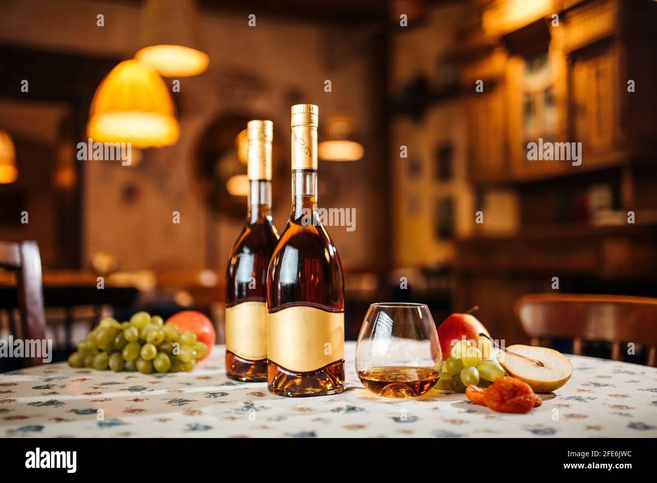 Elegant bottle of cognac with fruits Stock Photo
