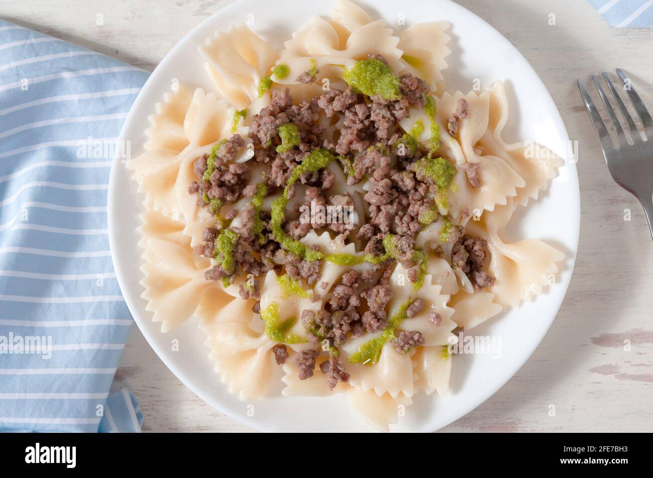 Delicious farfalle with freshly made pesto and minced meat Stock Photo