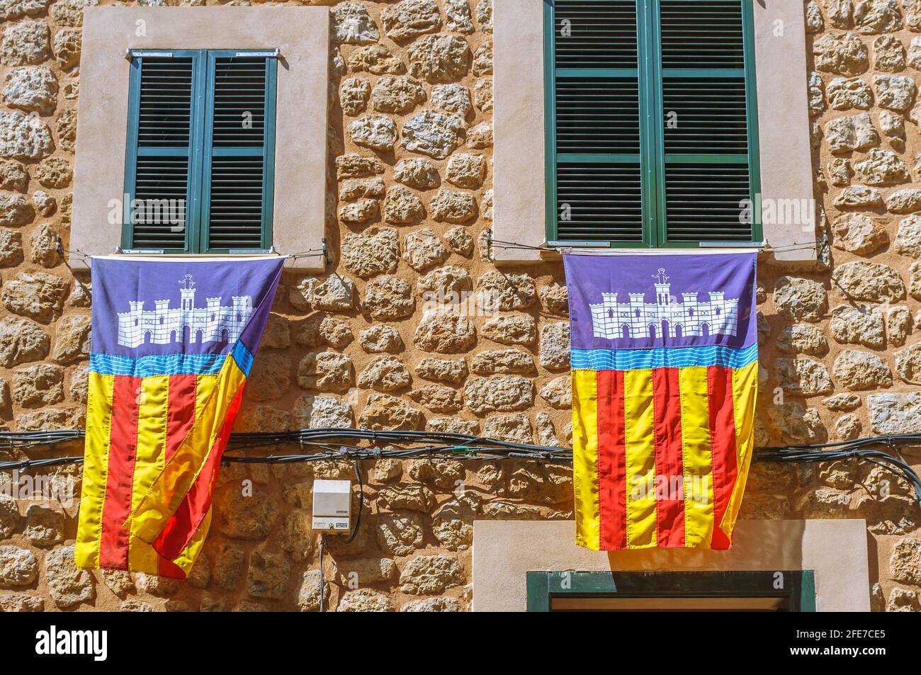 Majorcan flags hung from window frames during Es Firo. The Festival of Moors and Christians in the town of Soller Majorca Spain. Stock Photo