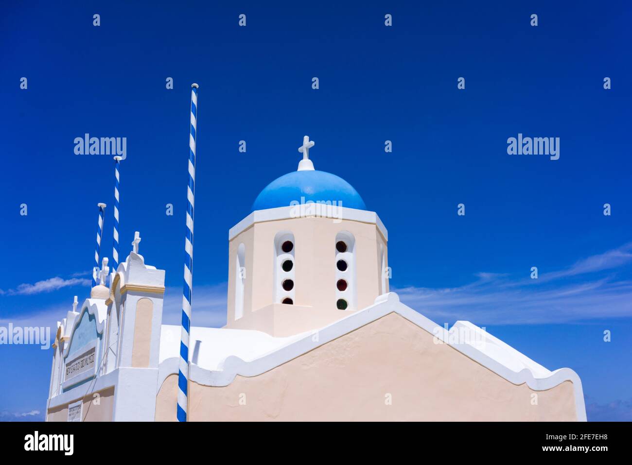 A church in Oia on the greek island of Santorini, Greece, set against a deep blue sky. Stock Photo