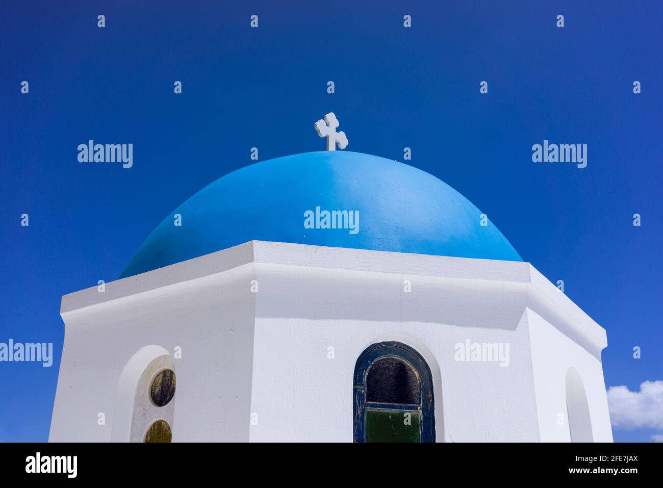 The blue dome of a church in the village of Oia on the greek island of Santorini Greece, against a deep blue sky. Stock Photo