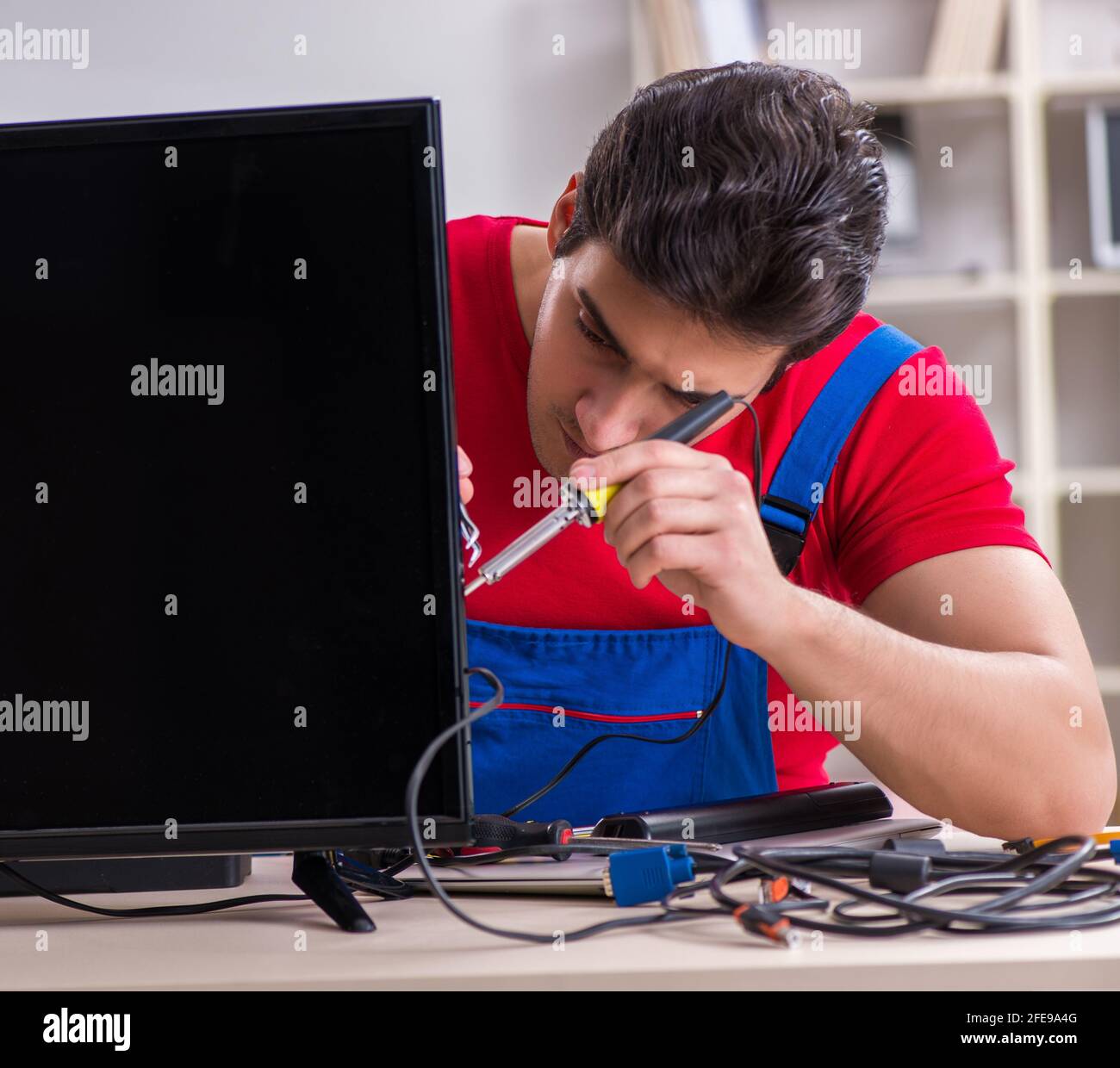 Tv Engineering Making The professional repair engineer repairing broken tv Stock Photo - Alamy