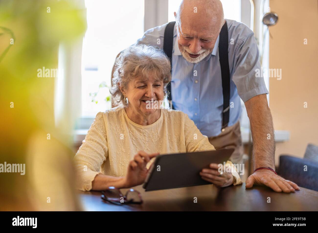 Happy senior couple using digital tablet at home Stock Photo