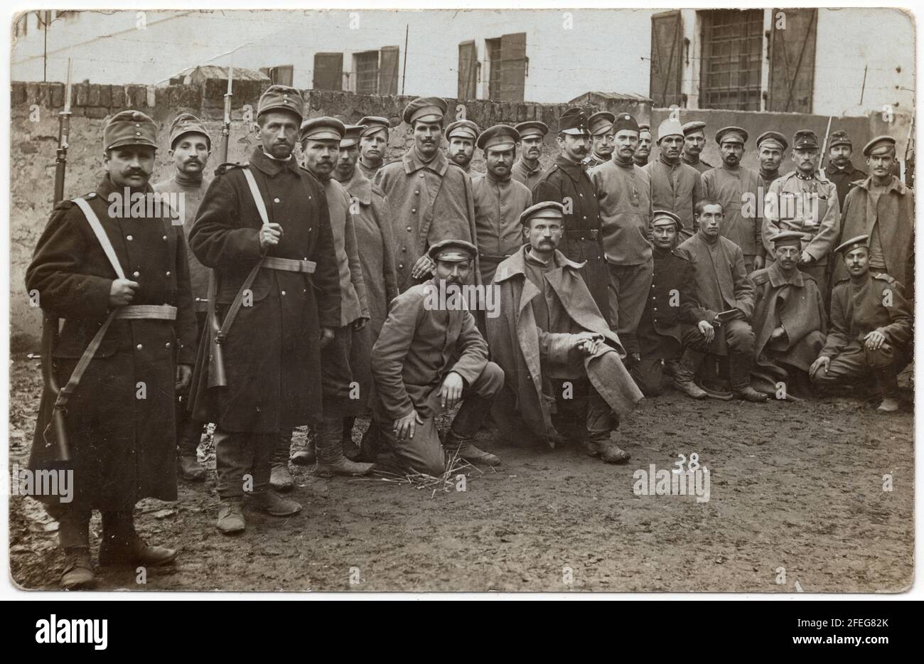 Russian prisoners of war guarded by Austro-Hungarian escort soldiers pictured during the First World War probably in the Austro-Hungarian POW Camp Josefstadt (now Josefov near Jaroměř in Central Bohemia, Czech Republic) depicted in the black and white vintage photograph by an unknown photographer dated from 1914 to 1918. Courtesy of the Azoor Photo Collection. Stock Photo