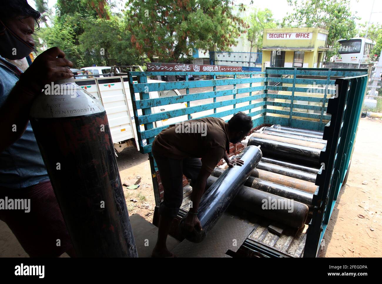 Chennai, India. 24th Apr, 2021. A worker loads oxygen cylinders on a van in Chennai, India, April 24, 2021. In the wake of the ongoing COVID-19 pandemic, hospitals across India have been reporting a shortage of oxygen supply and urged the federal government to replenish their stocks. Credit: Str/Xinhua/Alamy Live News Stock Photo