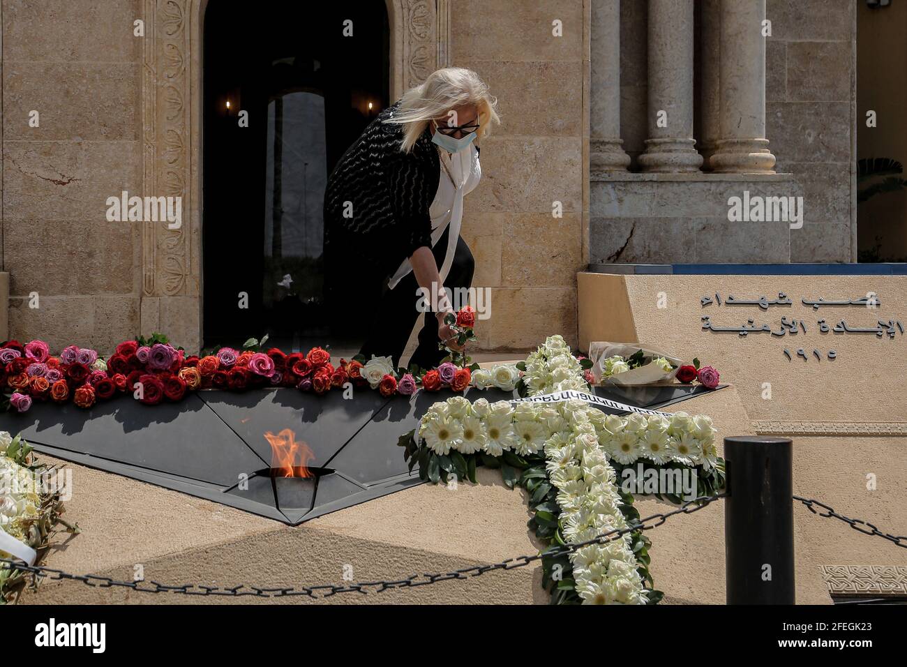 Antelias, Lebanon. 24th Apr, 2021. A lays roses outside a memorial