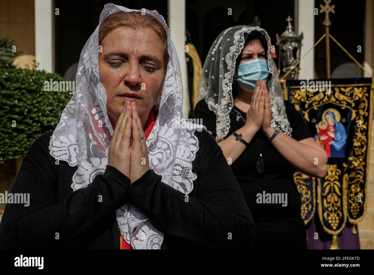 Antelias, Lebanon. 24th Apr, 2021. Lebanese Armenian women pray outside