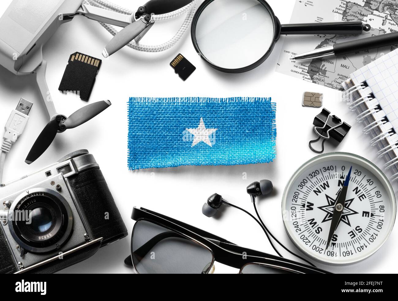 Flag of Somalia and travel accessories on a white background. Stock Photo