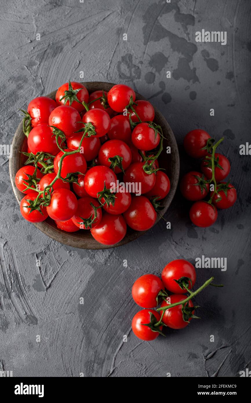 Fresh cherry tomatoes the on gray background Stock Photo - Alamy