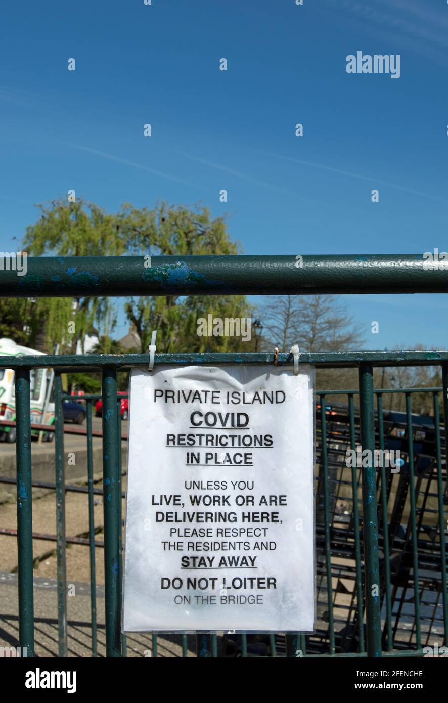 covid-19 notice on the footbridge between twickenham and eel pie island asking non-residents to stay away, twickenham, middlesex, england Stock Photo