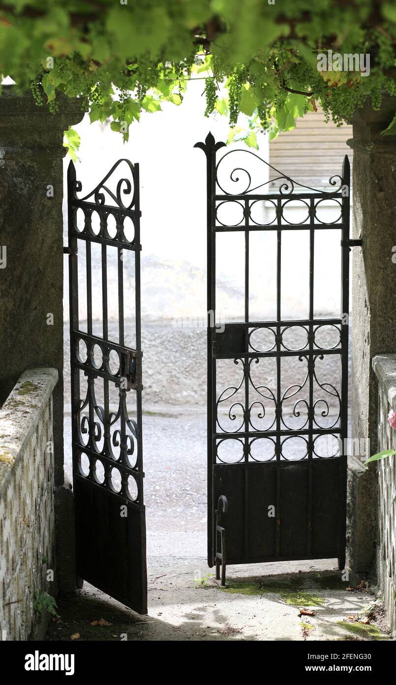 iron gate at the exit of the courtyard of an old european house Stock