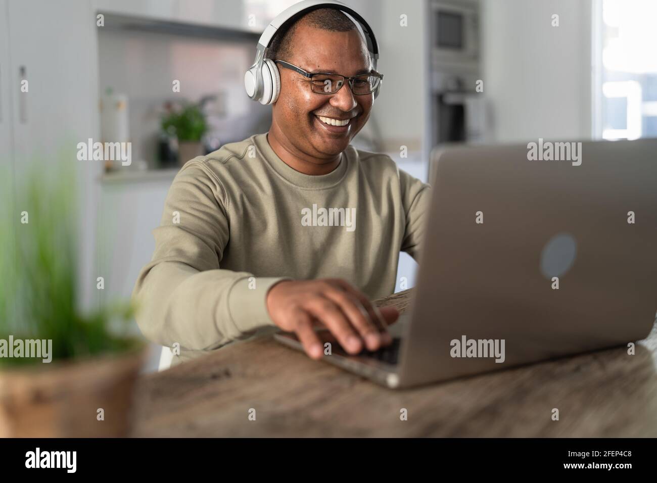 Happy senior man having fun doing video call using laptop at home - Technology and smart working concept Stock Photo