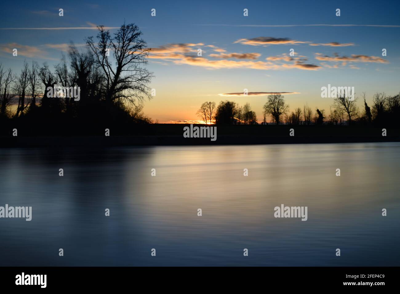amazing sunset on the Muzza river Stock Photo - Alamy