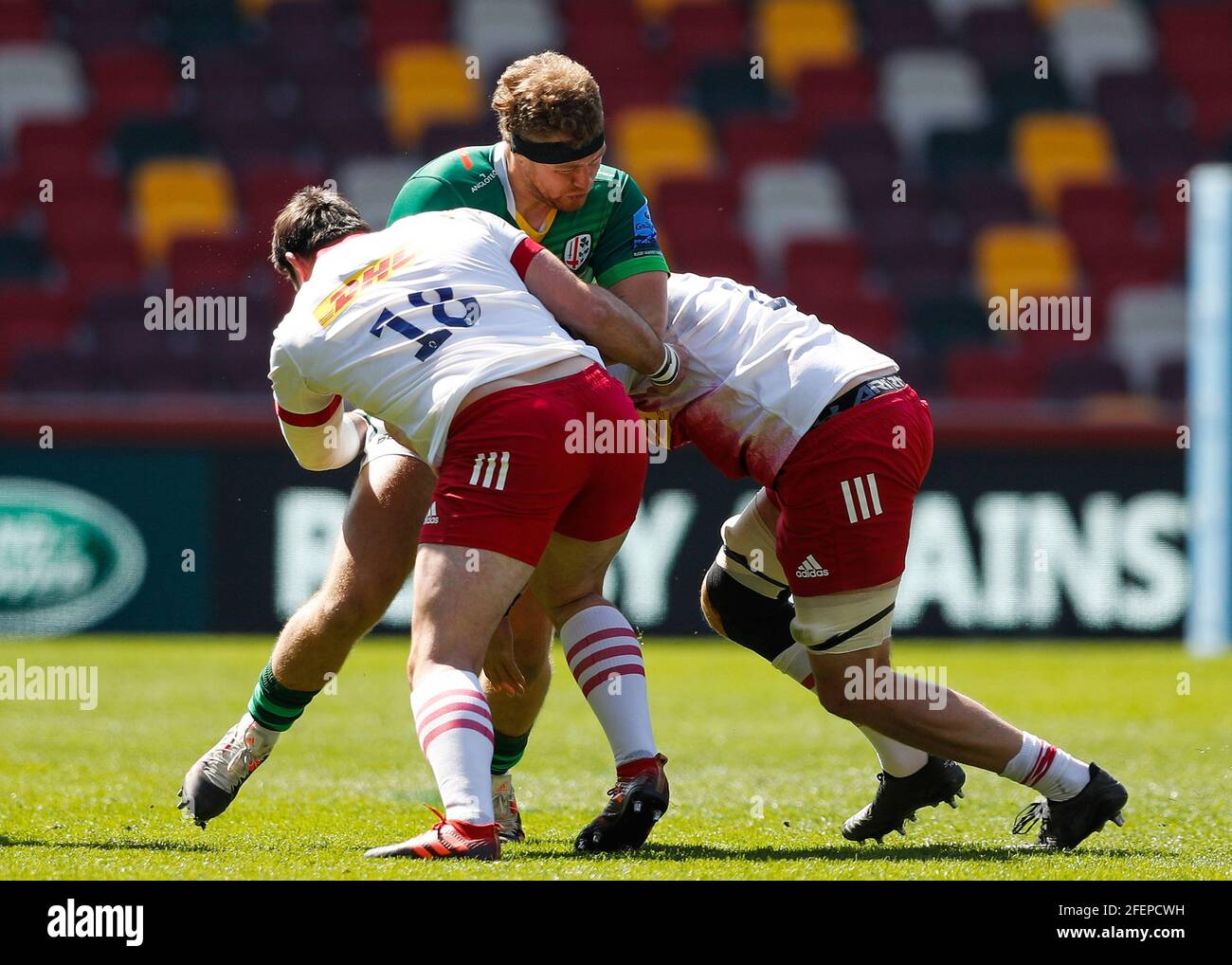 Brentford Community Stadium, London, UK. 24th Apr, 2021. Gallagher Premiership Rugby, London Irish versus Harlequins; Harry Elrington of London Irish tackled by Will Collier and Joe Marchant of Harlequins Credit: Action Plus Sports/Alamy Live News Stock Photo