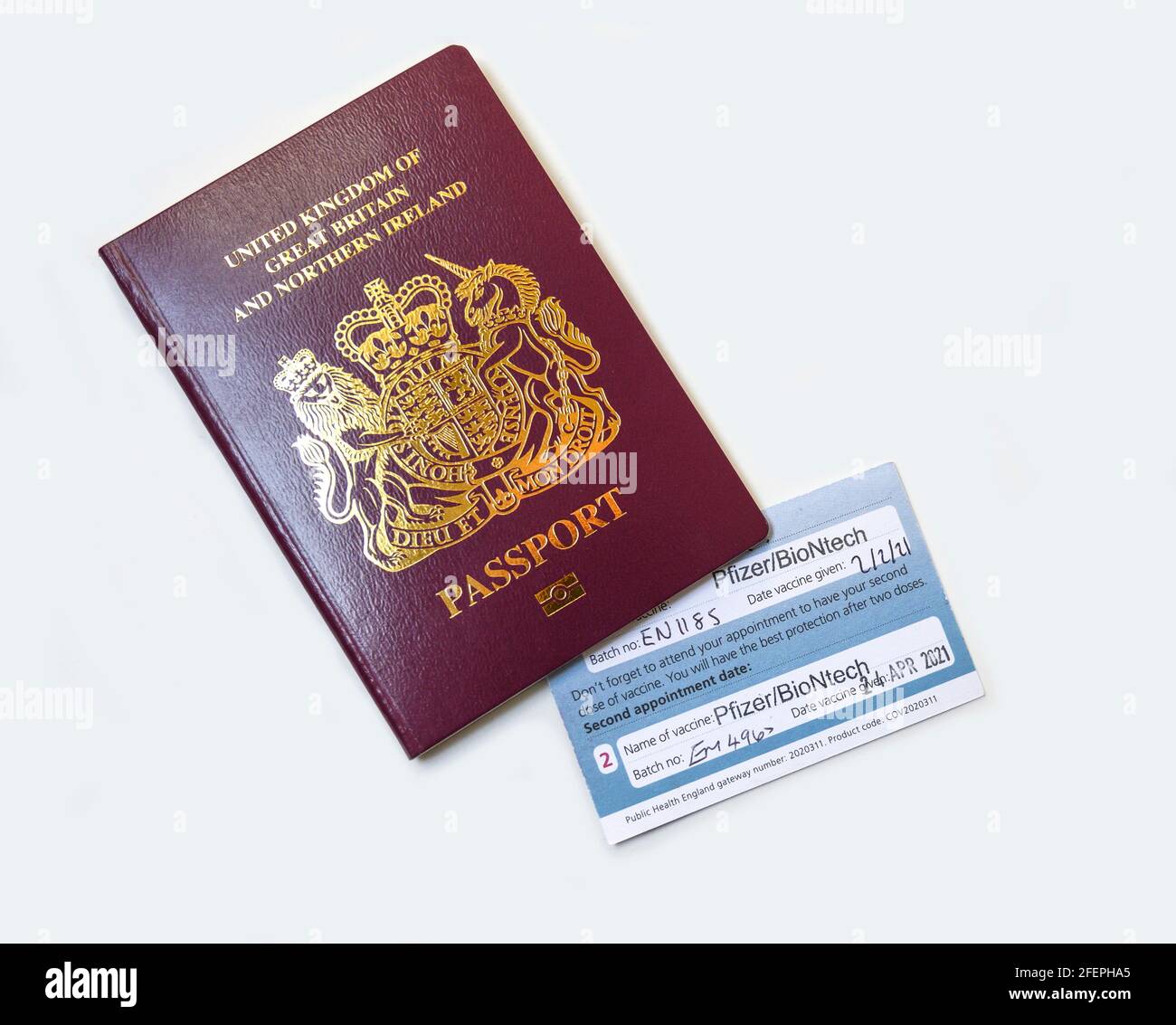 London, UK. 24 April 2021. Vaccine certificate issued by NHS UK with second Pfizer/BioNtech vaccination stamped, certificate tucked inside passport. Half the UK population is reported to have now received the first vaccine. Credit: Malcolm Park/Alamy Live News. Stock Photo