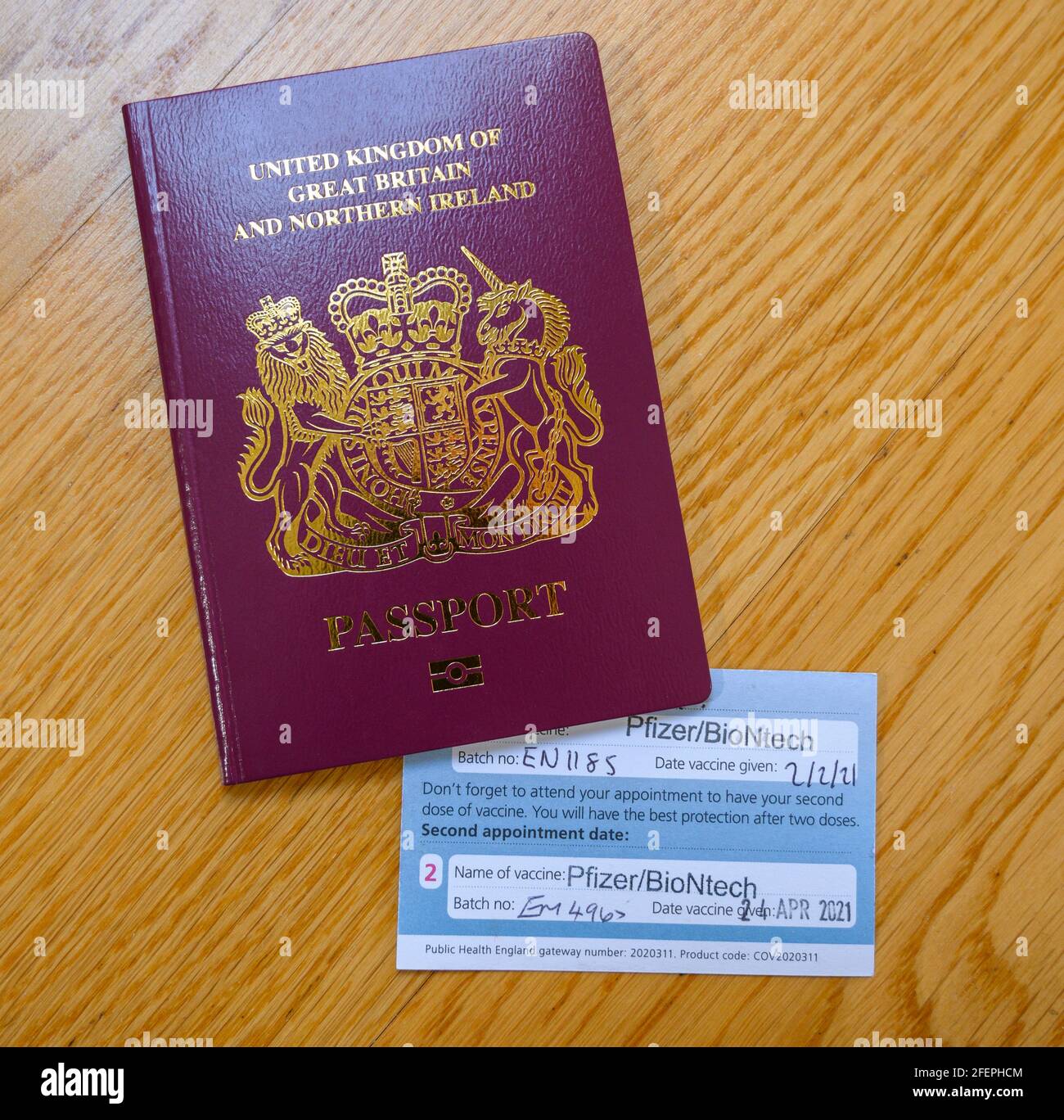 London, UK. 24 April 2021. Vaccine certificate issued by NHS UK with second Pfizer/BioNtech vaccination stamped, certificate tucked inside passport. Half the UK population is reported to have now received the first vaccine. Credit: Malcolm Park/Alamy Live News. Stock Photo