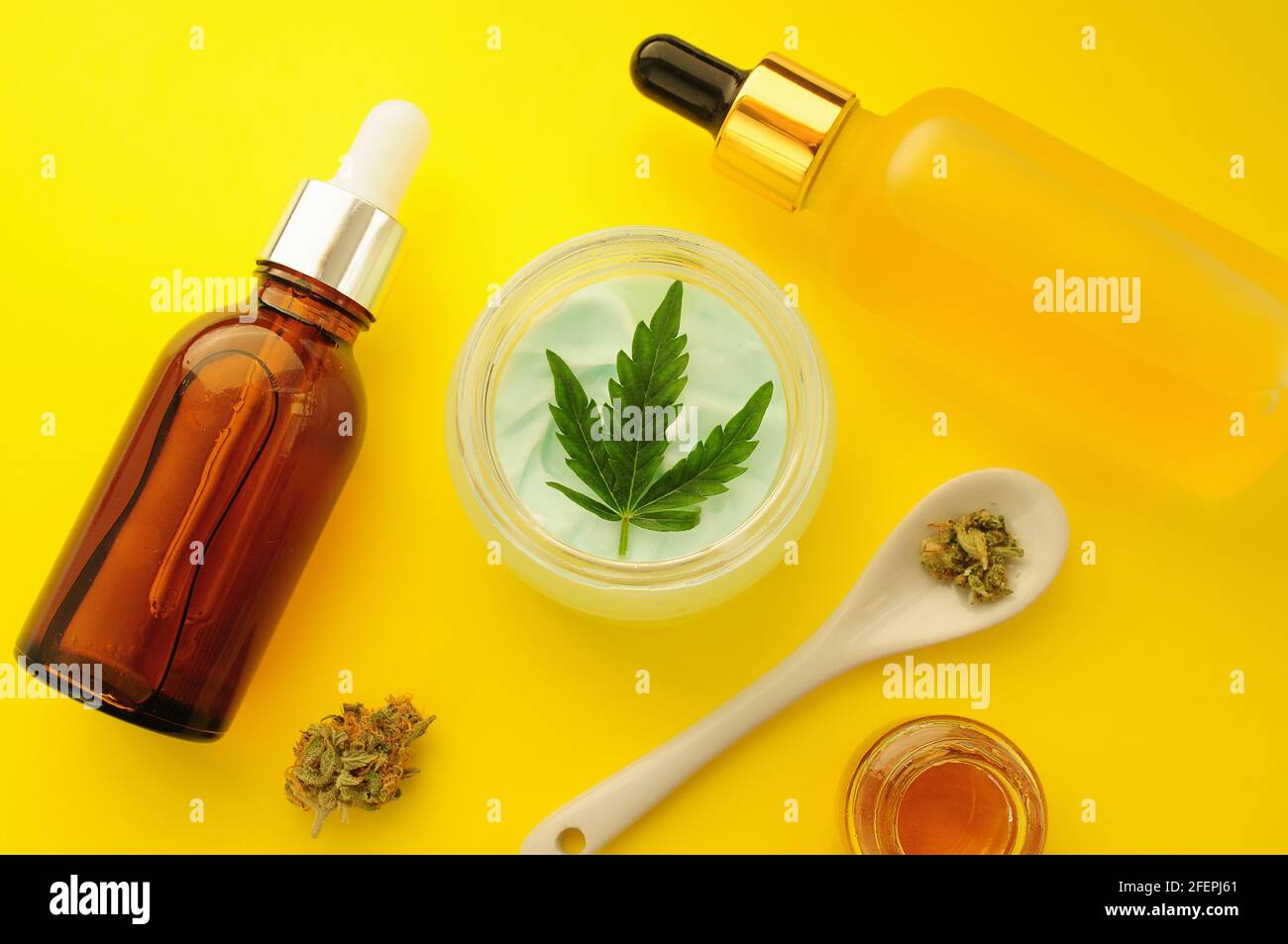 Cannabis cosmetics, cbd oil. Marihuana extract in cosmetology. Flat lay, yellow background. Home relaxation, spa recreation, pastime therapy. Stock Photo