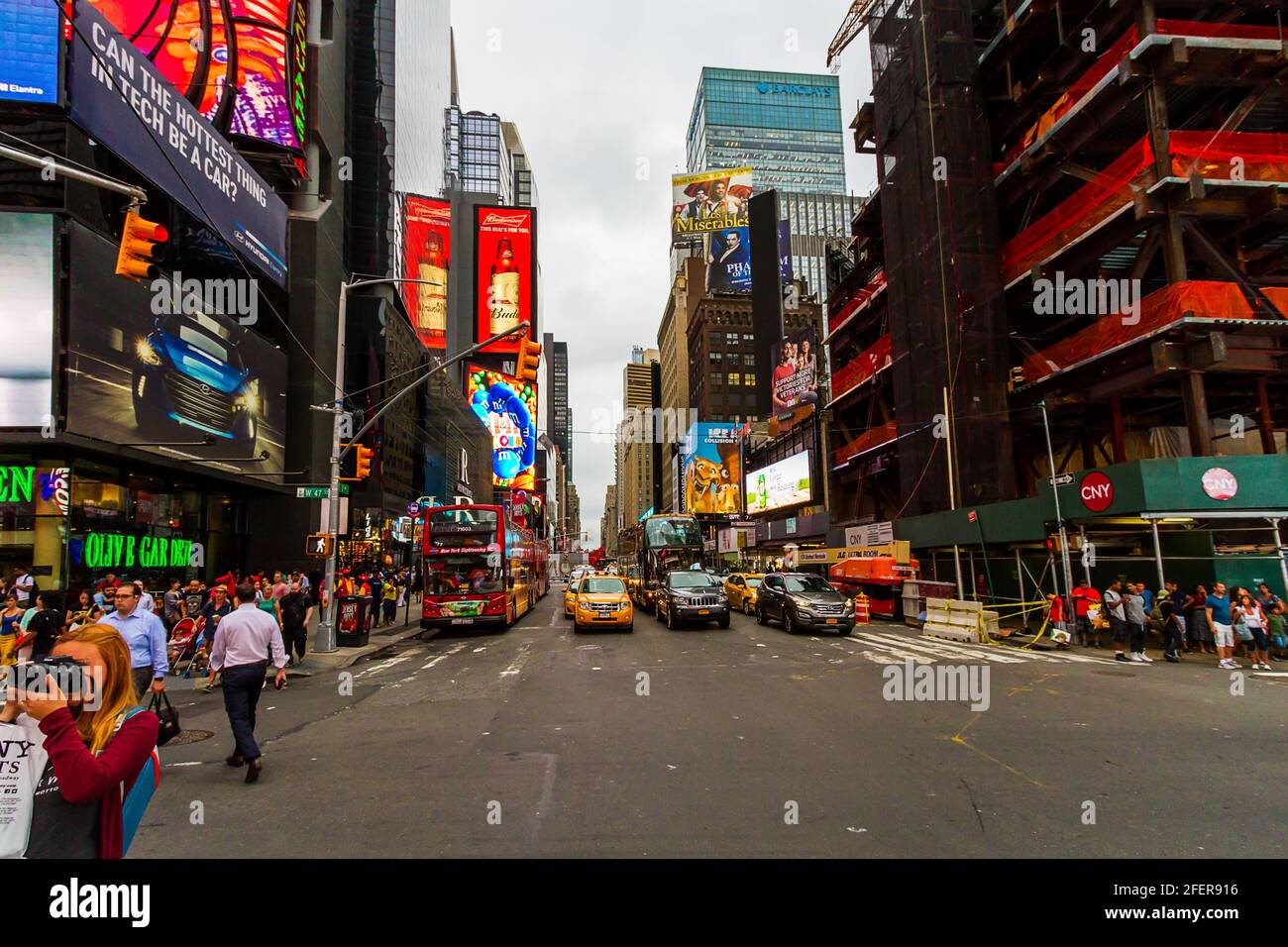 The traffic and people at Times Square on a busy summer evening with tourists around Stock Photo