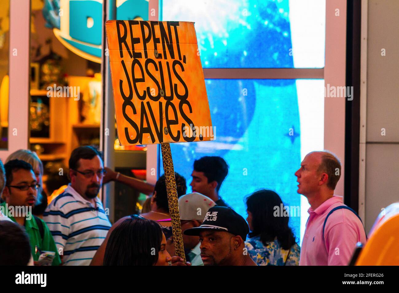 A group of missionary workers carrying 'Repent, Jesus Saves' placard at Times Square Stock Photo