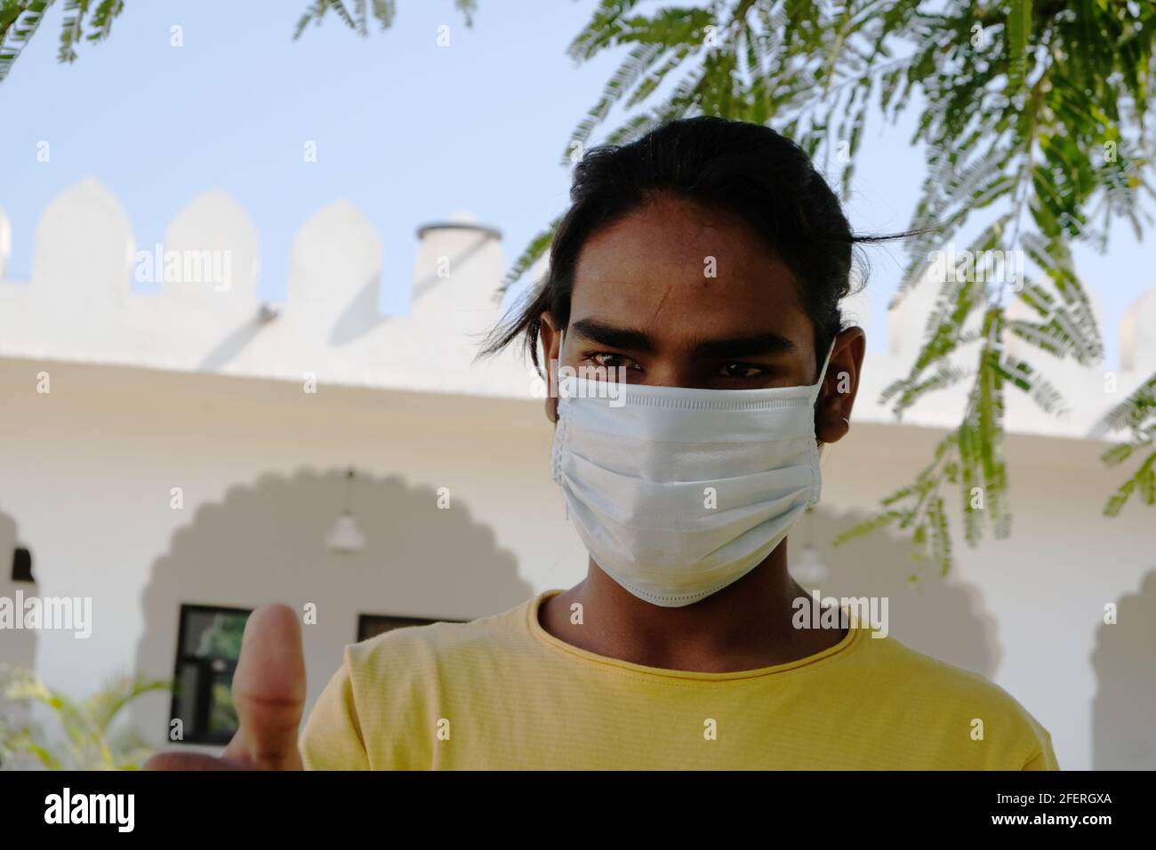 Portrait of an Indian young male with a face mask looking aside Stock ...